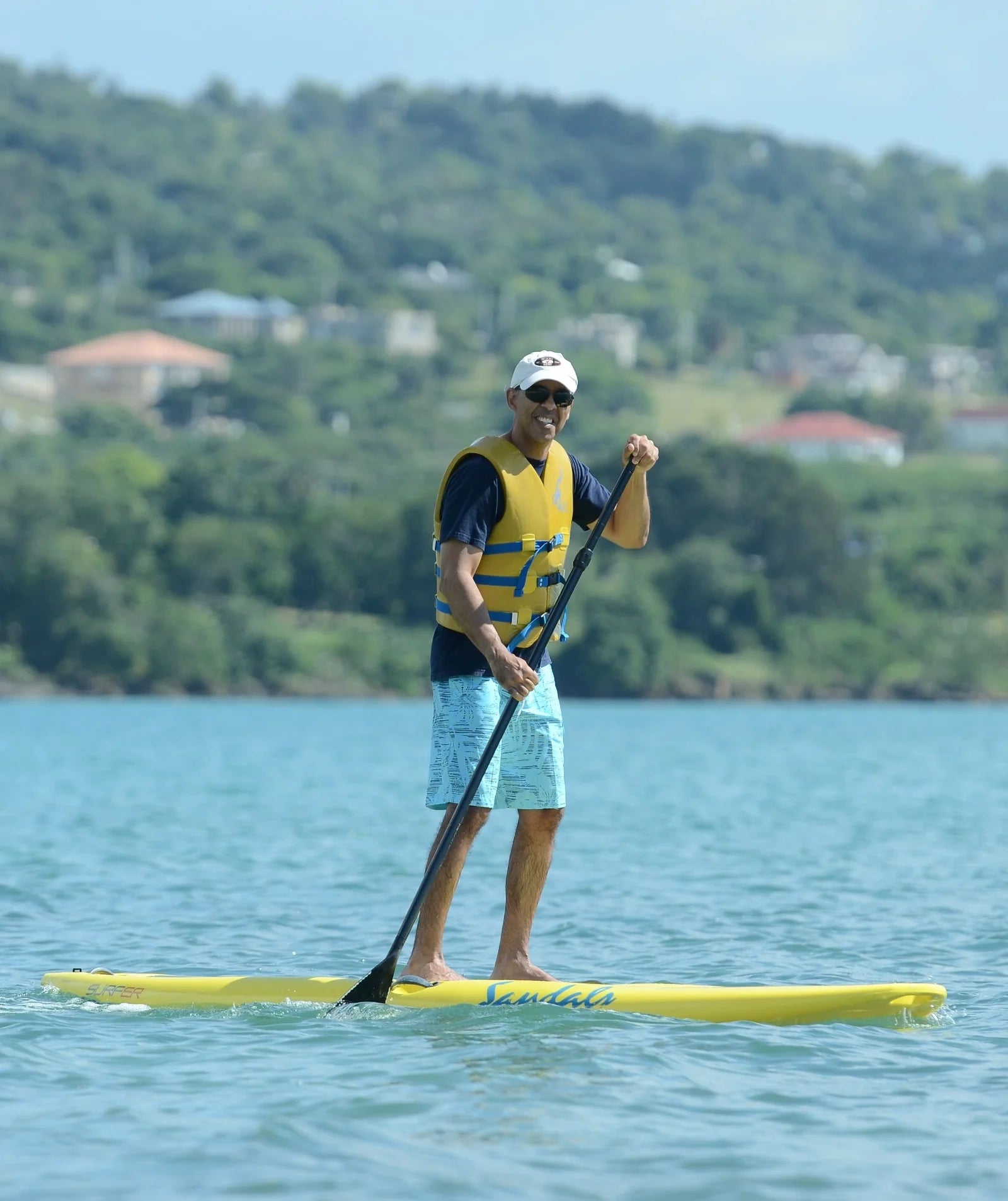 Juarez, founder of Brazilian Botanics, paddleboarding outdoors